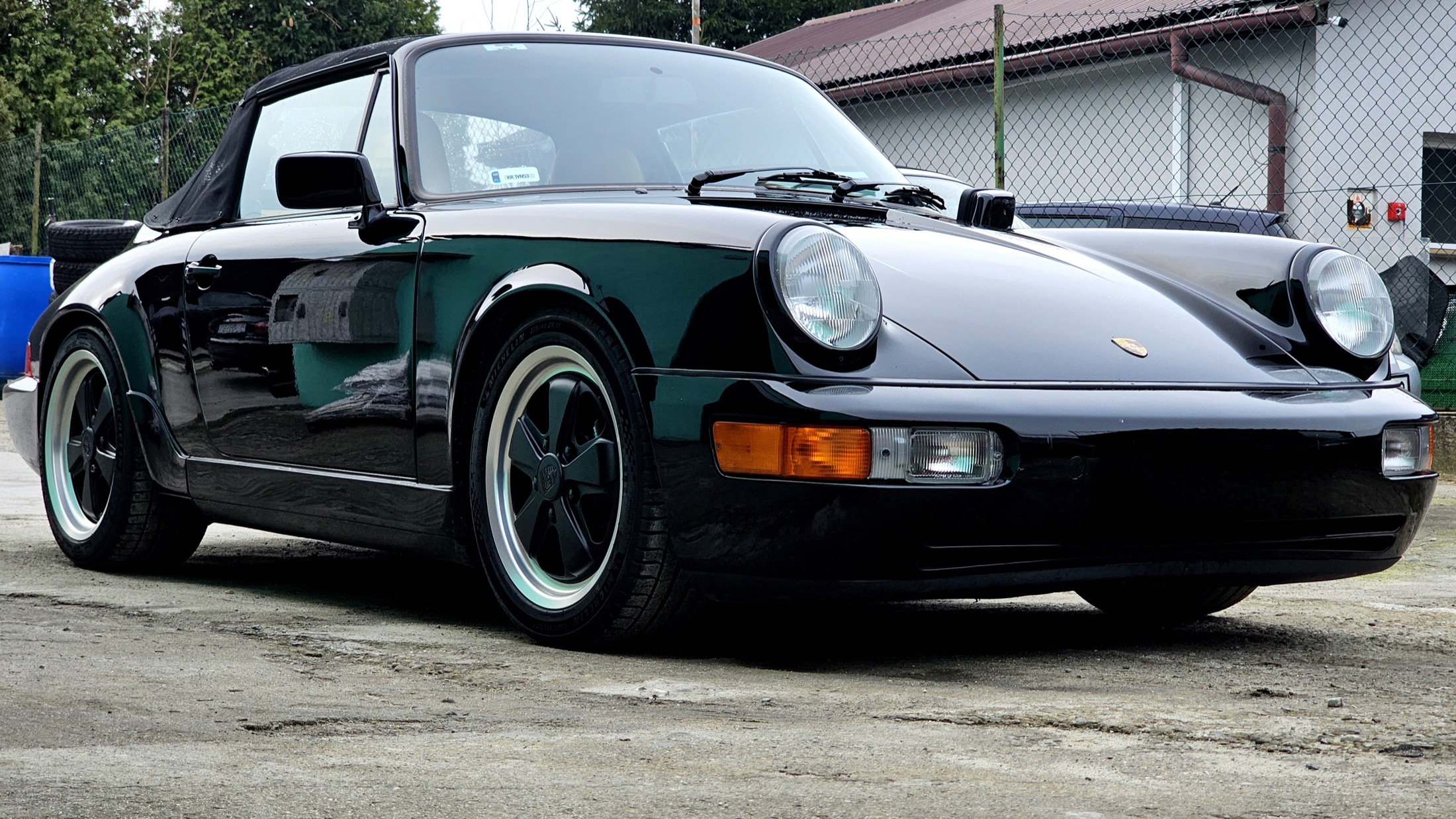 Czarne Porsche 911 przed warsztatem